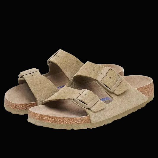 Pair of tan sandals with double straps on a white background