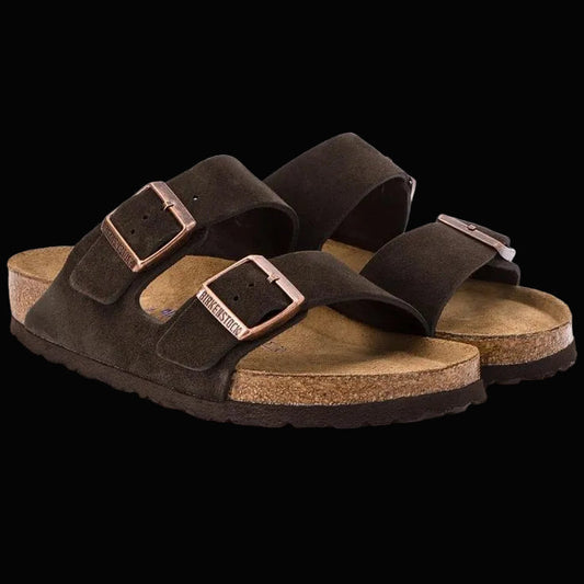 Pair of brown sandals with cork soles on a white background