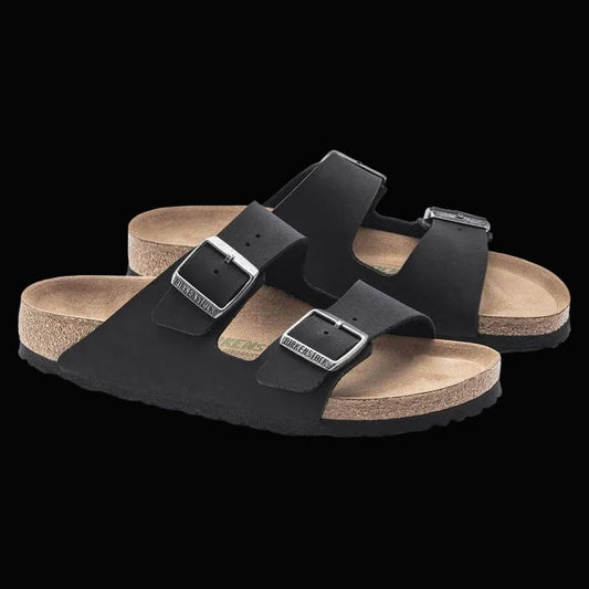 Black sandals with cork soles on a white background